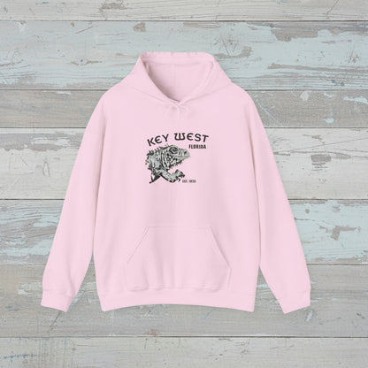 Pink hoodie with 'Key West, Florida' text on a wooden surface