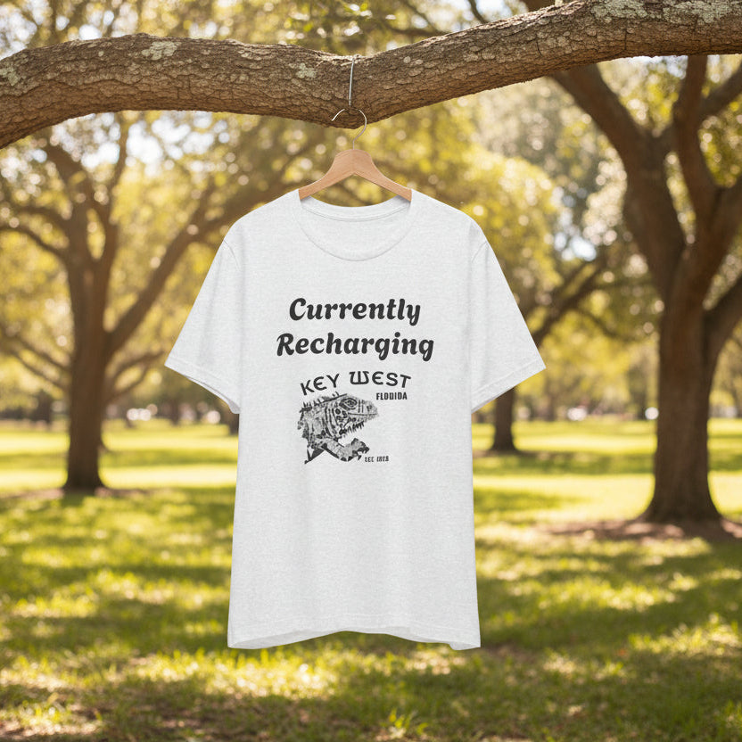 White t-shirt with key west text and graphic on a hanger under a tree in a park