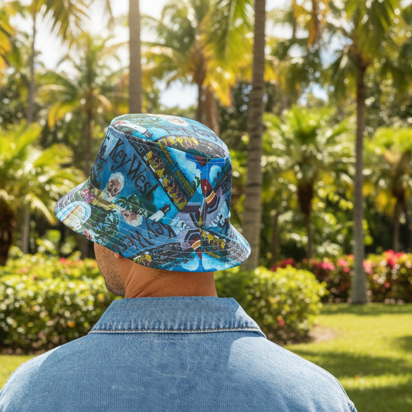 Person wearing a floral bucket hat in a tropical setting with palm trees and greenery.