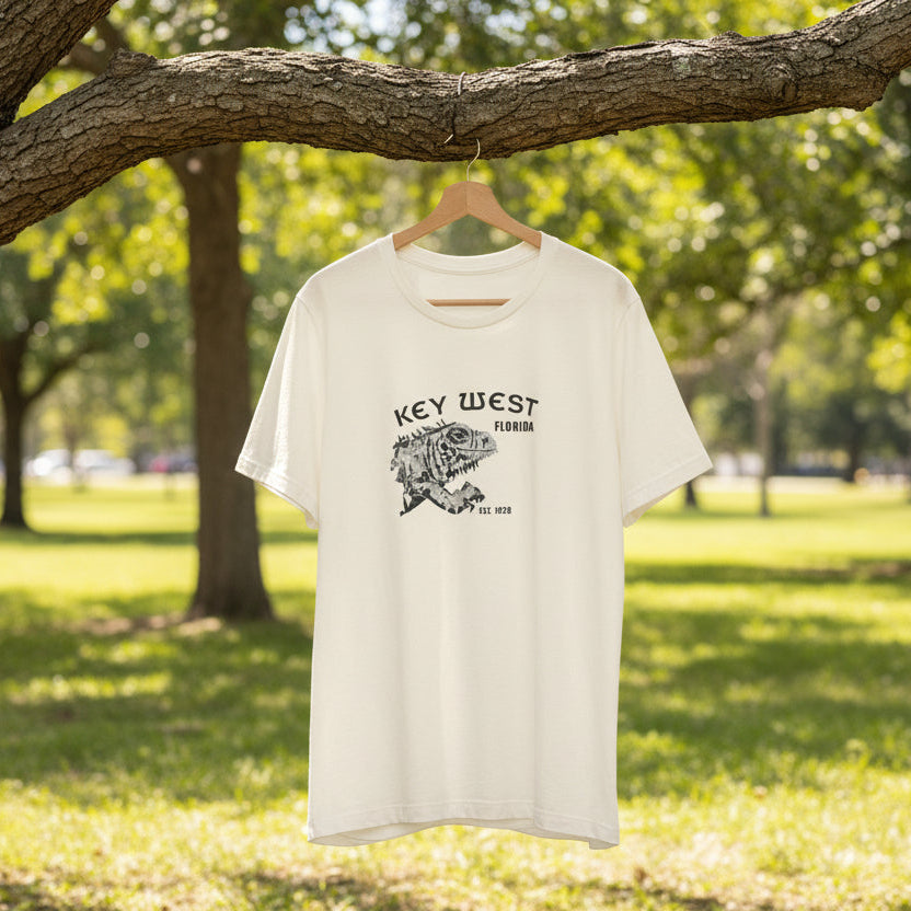 White t-shirt with 'Key West, Florida' text and graphic on a hanger against a natural background.