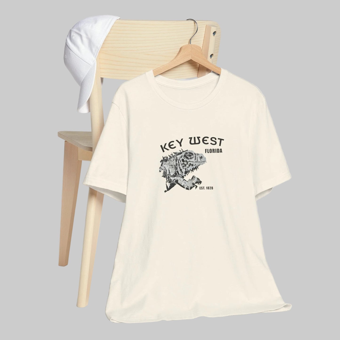 White t-shirt with 'Key West, Florida' print on a wooden chair against a gray background