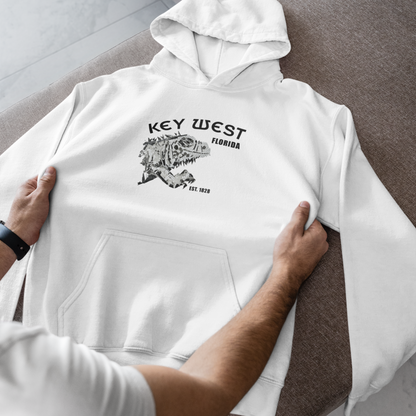 White hoodie with 'Key West, Florida' print held by a person on a marble surface.